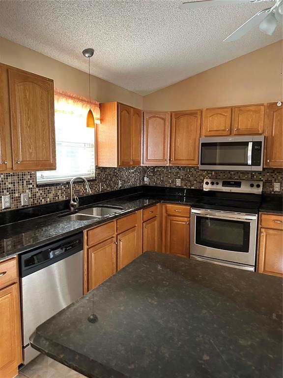 917 Camino Del Rey Drive Lady Lake, FL 32159 - Photo 14 of 46 a kitchen with granite countertop a stove top oven sink and cabinets