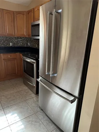 a kitchen with a sink a microwave and cabinets