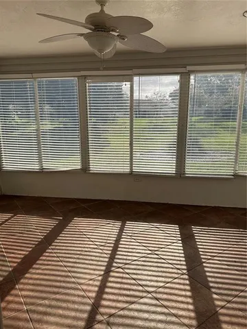 a view of empty room with floor to ceiling windows
