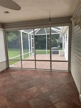 a view of a room with wooden floor and windows