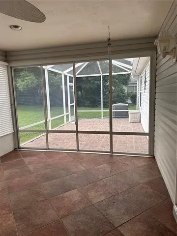 a view of a room with wooden floor and windows
