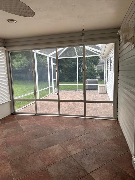 917 Camino Del Rey Drive Lady Lake, FL 32159 - Photo 19 of 46 a view of empty room with floor to ceiling windows