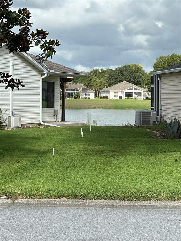 917 Camino Del Rey Drive Lady Lake, FL 32159 - Photo 2 of 46 a view of a house with a big yard and potted plants