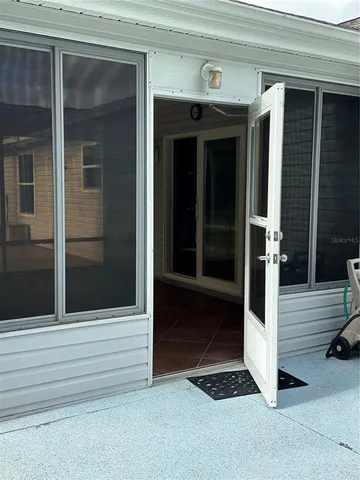 a view of a room with wooden floor and a window