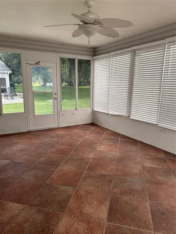 a view of an empty room with a small yard