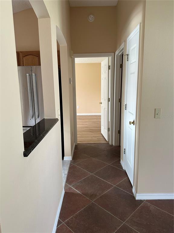 917 Camino Del Rey Drive Lady Lake, FL 32159 - Photo 6 of 46 a view of a hallway with wooden cabinets and staircase