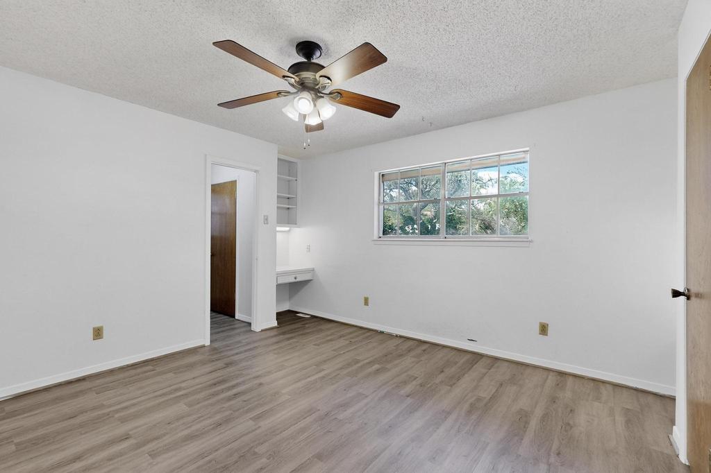 5180 Farm To Market Road 972 Granger, TX 76530 - Photo 27 of 39 a view of an empty room with wooden floor and a window