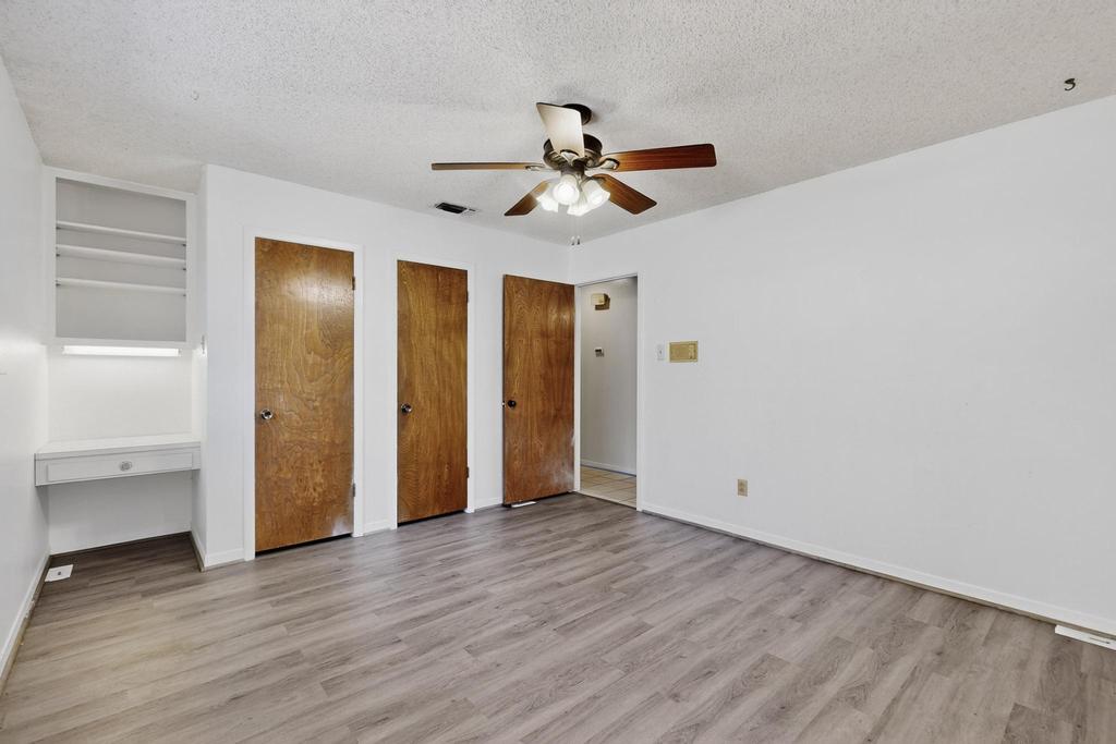 5180 Farm To Market Road 972 Granger, TX 76530 - Photo 29 of 39 an empty room with wooden floor a ceiling fan and entryway