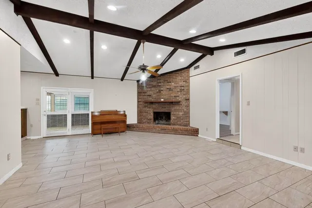 a view of living room with furniture and a fireplace