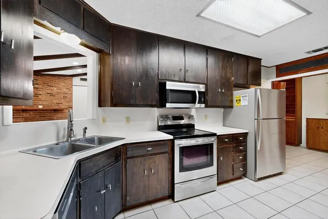 a kitchen with a sink appliances and cabinets