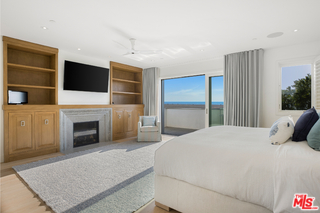 1347 Palisades Beach Road Santa Monica, CA 90401 - Photo 30 of 64 a bedroom with a bed and a fireplace