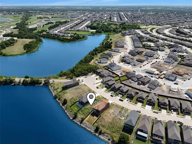 an aerial view of a residential houses with outdoor space