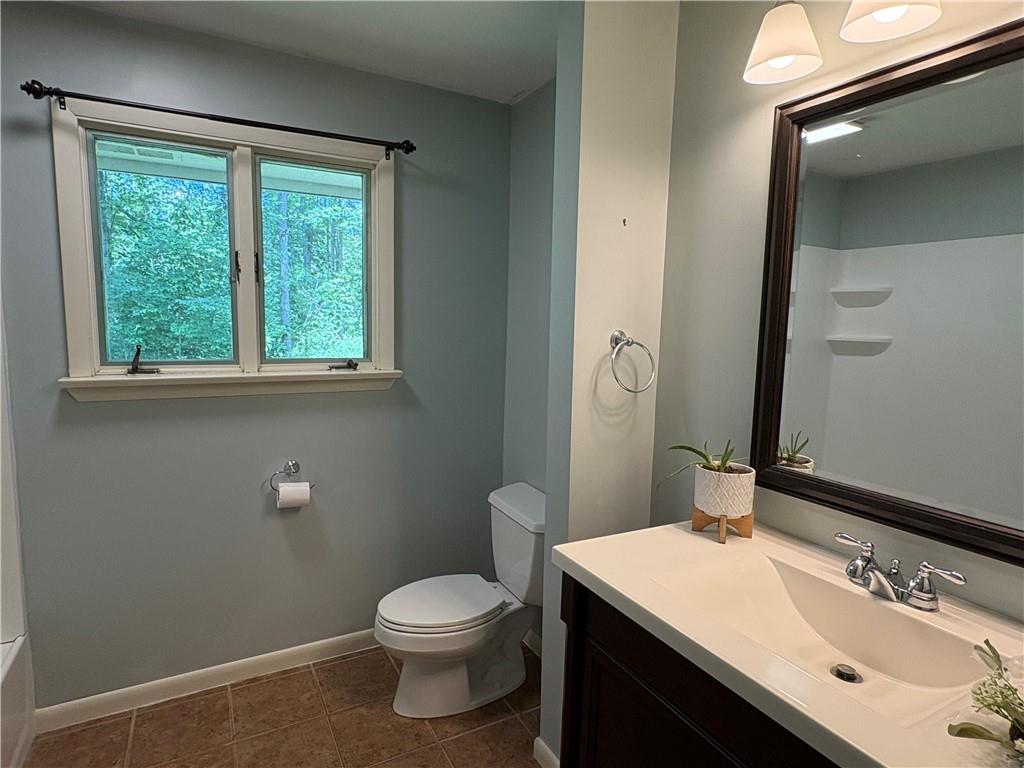 320 Cherry Hill Road Greenville, PA 16125 - Photo 16 of 38 a bathroom with a granite countertop sink a mirror and a toilet