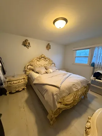 a bedroom with a bed and a chandelier