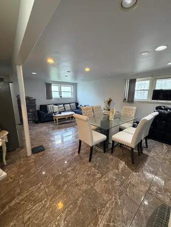 a living room with couches and a flat screen tv