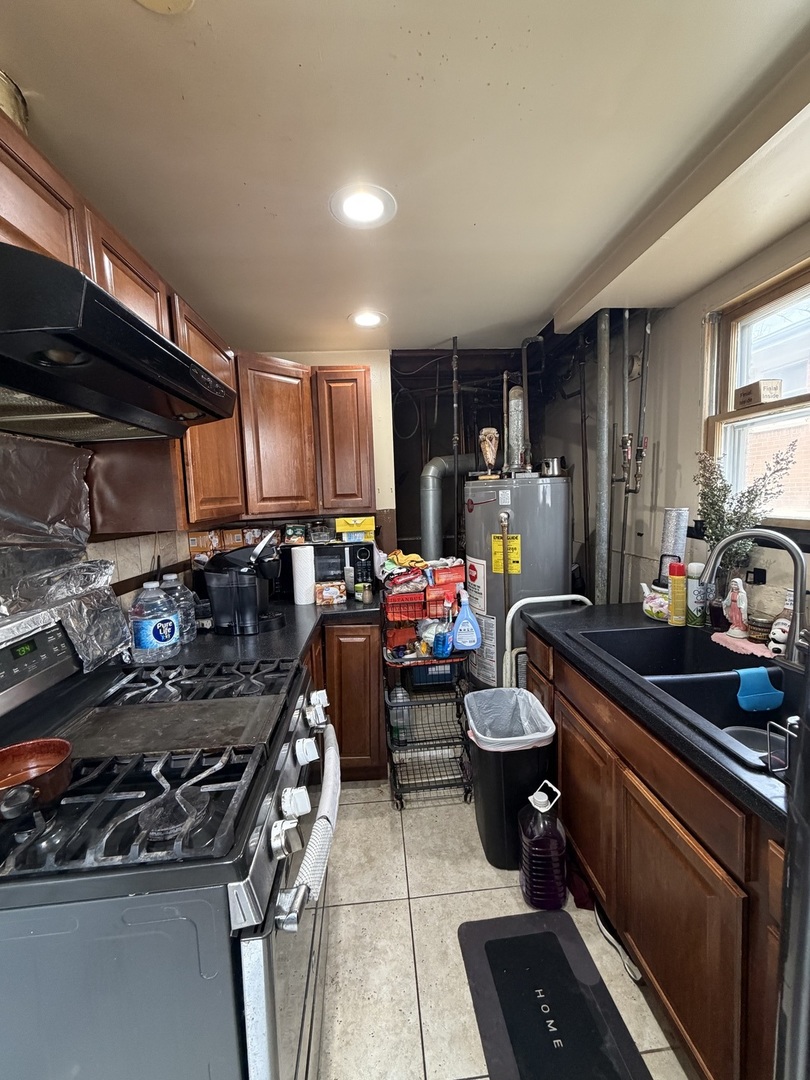 1643 Sycamore Street Des Plaines, IL 60018 - Photo 20 of 27 a kitchen with a stove and a sink