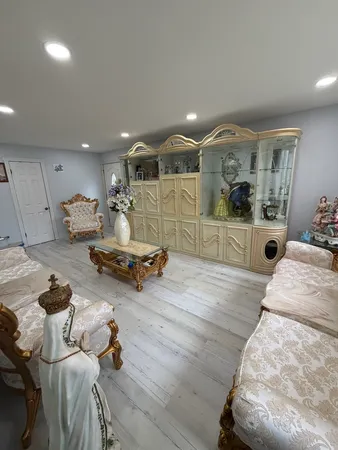 a bedroom with furniture and a wooden floor