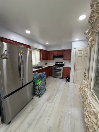 a kitchen with stainless steel appliances a refrigerator and a stove top oven