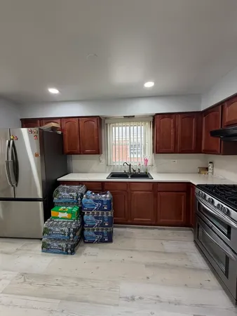 a kitchen with stainless steel appliances granite countertop a stove a sink and a refrigerator