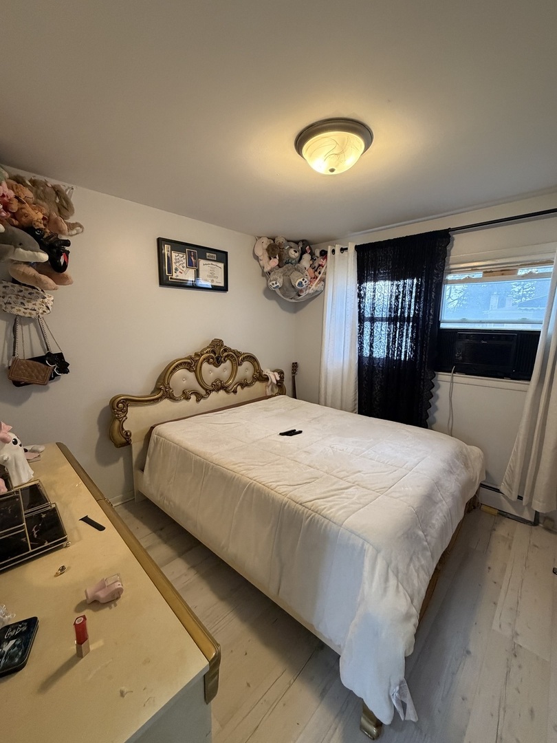 1643 Sycamore Street Des Plaines, IL 60018 - Photo 8 of 27 a bedroom with a bed and window