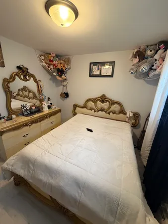 a bedroom with a bed and a dresser