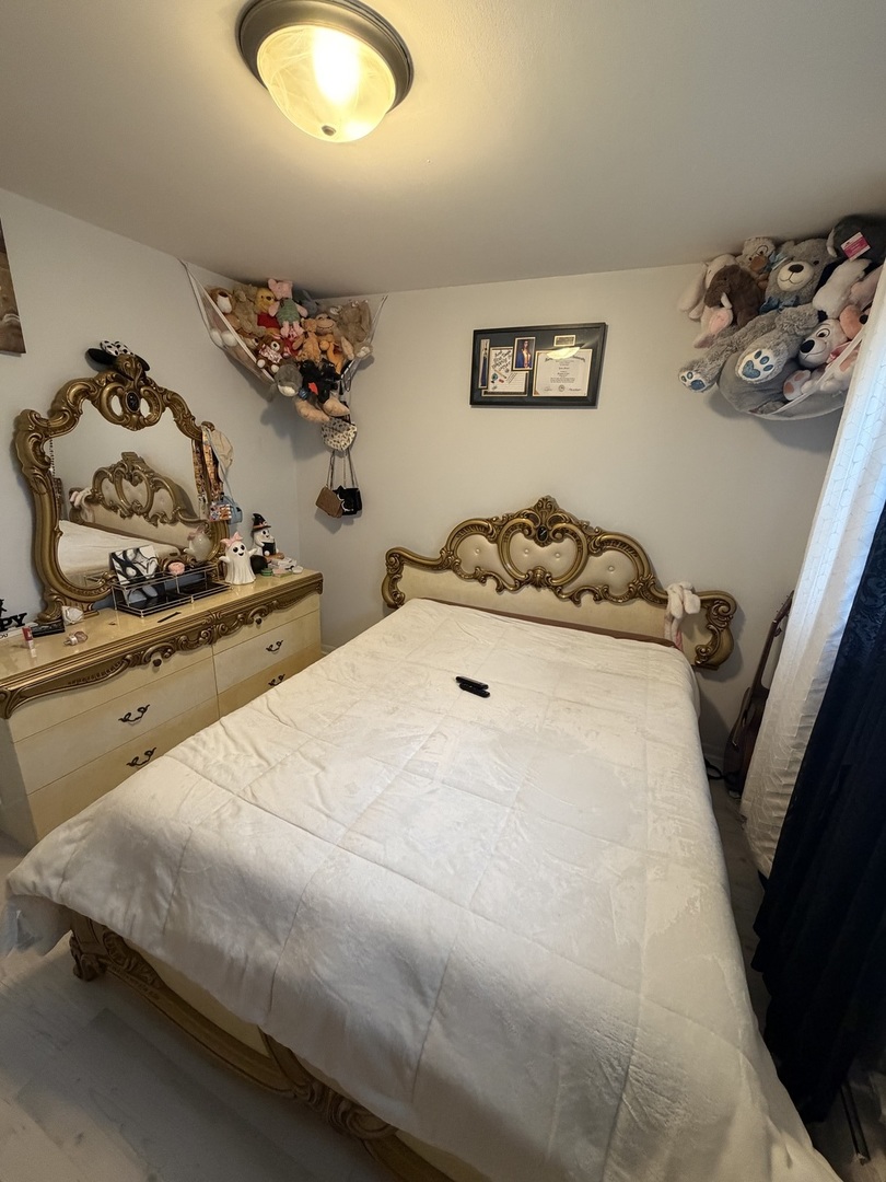 1643 Sycamore Street Des Plaines, IL 60018 - Photo 9 of 27 a bedroom with a bed and a dresser