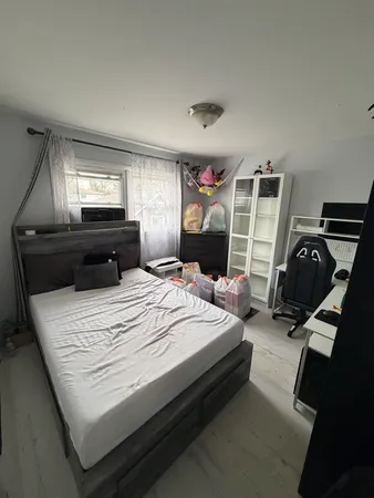 a bed sitting in a bedroom and dresser