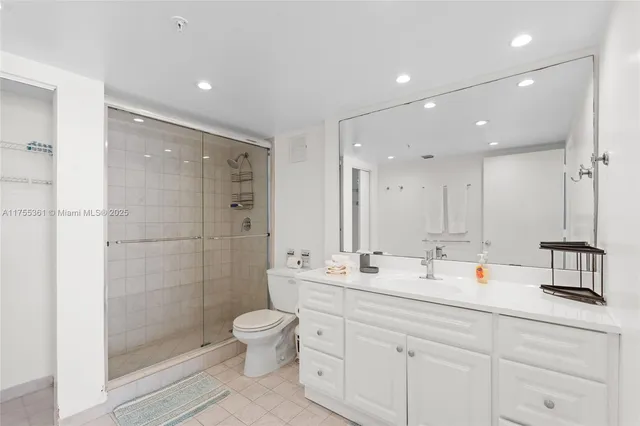 a bathroom with a double vanity sink toilet mirror and shower