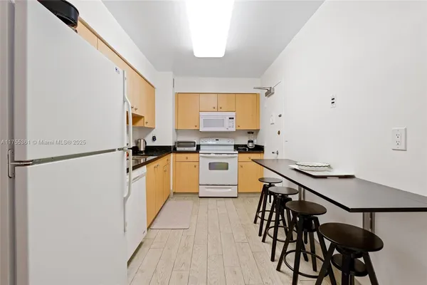 a kitchen with a table and chairs