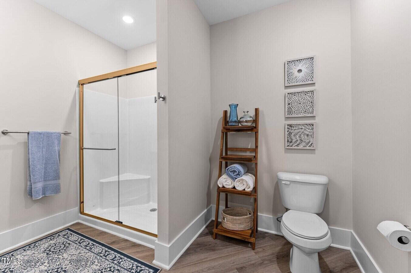 1001 Mulford Court, Unit B1 Knightdale, NC 27545 - Photo 21 of 41 a white toilet sitting next to a bathroom sink