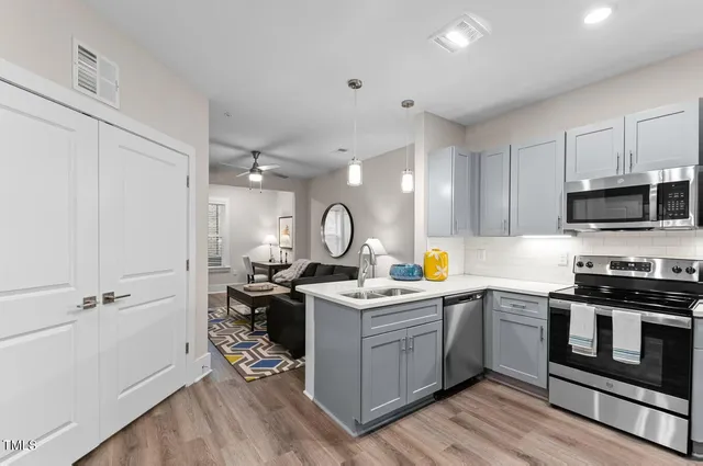 a kitchen with a stove a sink and a microwave