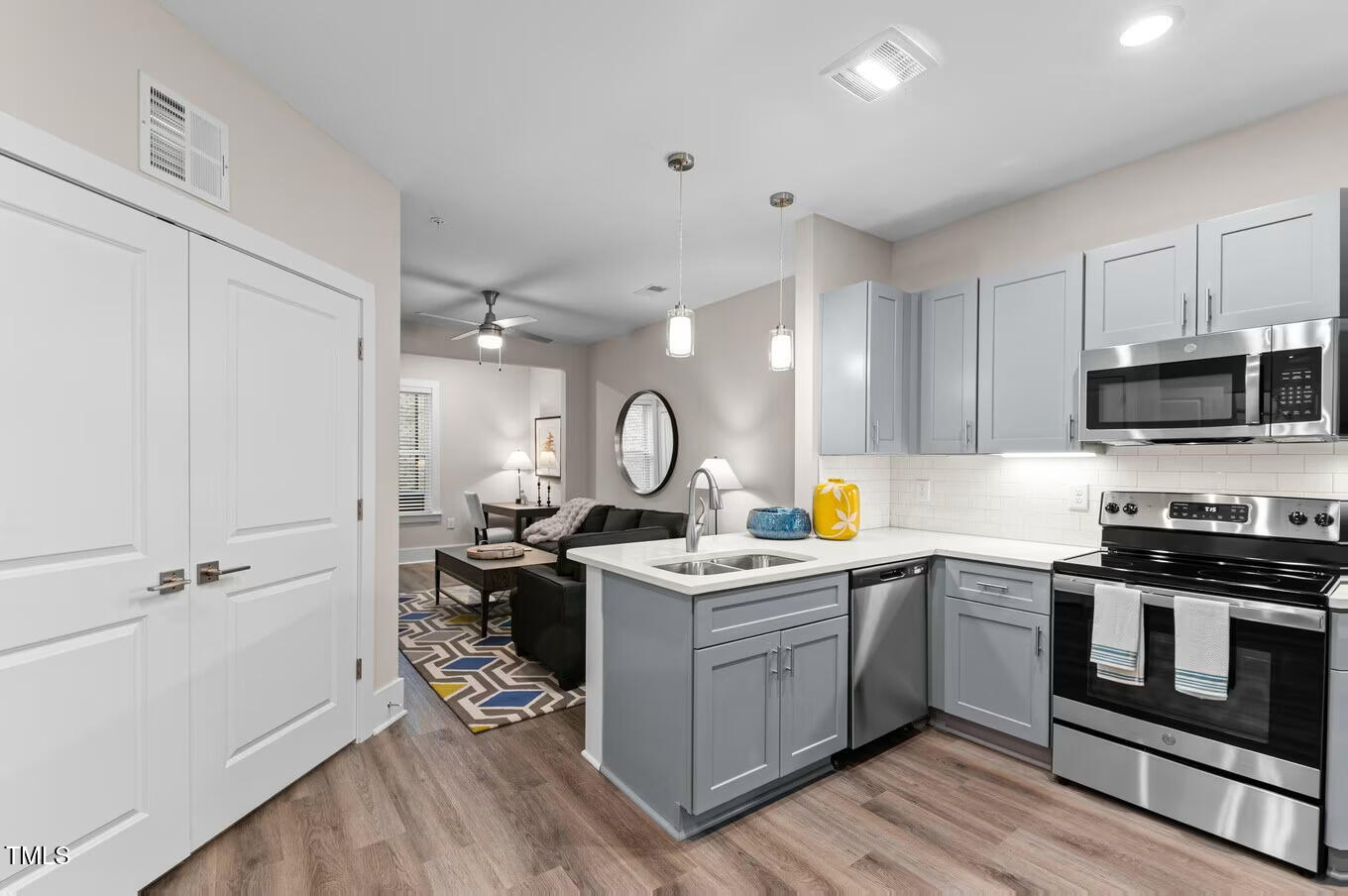 1001 Mulford Court, Unit B1 Knightdale, NC 27545 - Photo 23 of 41 a kitchen with a stove a sink and a microwave