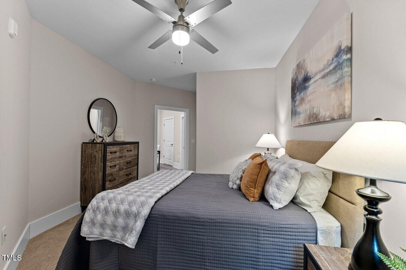 1001 Mulford Court, Unit B1 Knightdale, NC 27545 - Photo 7 of 41 a bedroom with a bed and a chandelier