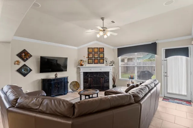 a living room with furniture a fireplace and a flat screen tv