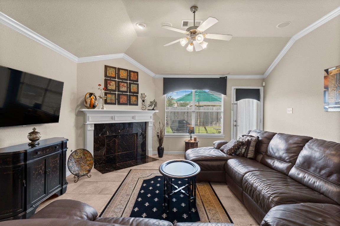 4618 Countrypines Drive Spring, TX 77388 - Photo 16 of 48 a living room with furniture a fireplace and a flat screen tv