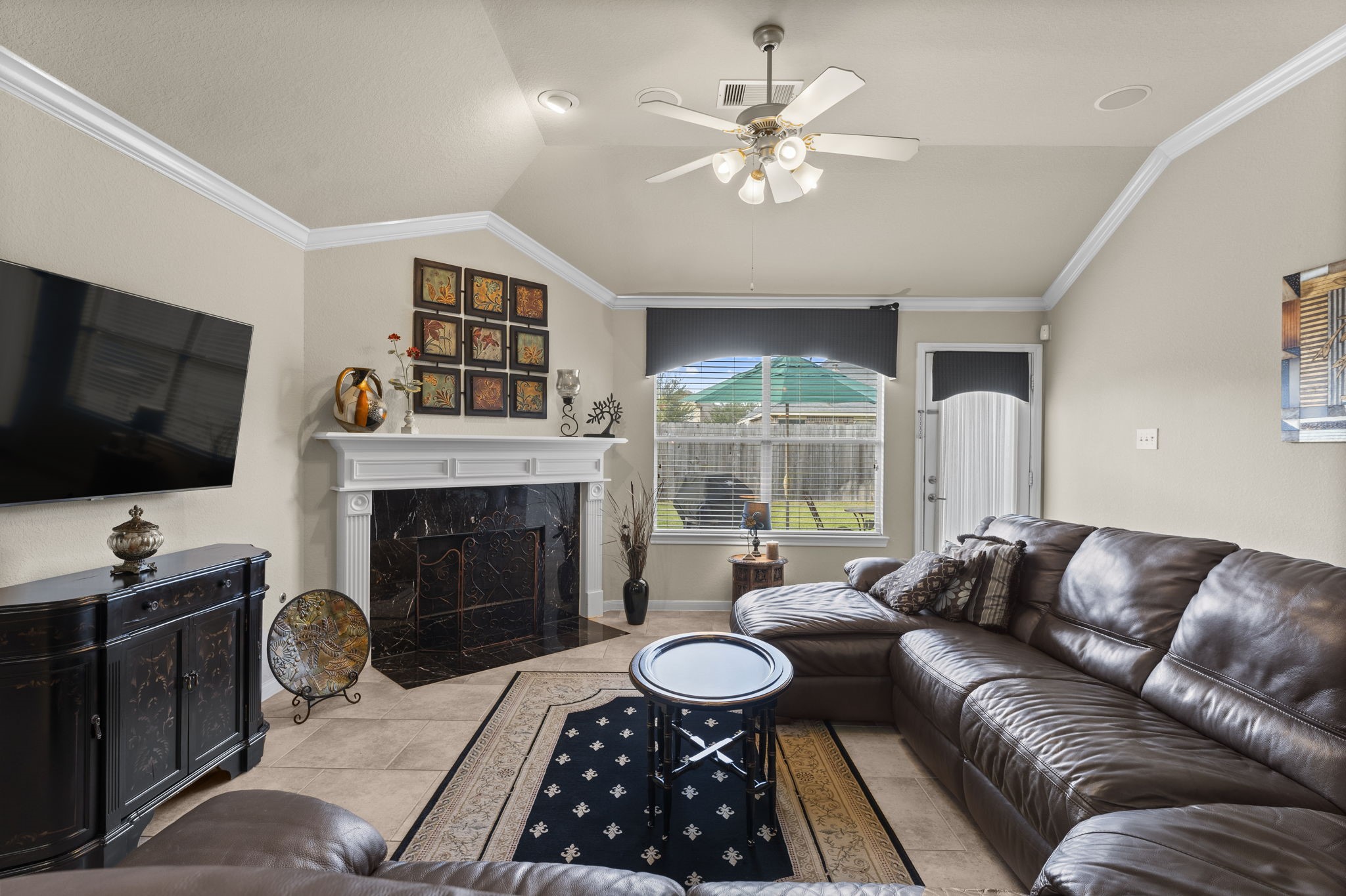 4618 Countrypines Drive Spring, TX 77388 - Photo 16 of 48 a living room with furniture a fireplace and a flat screen tv