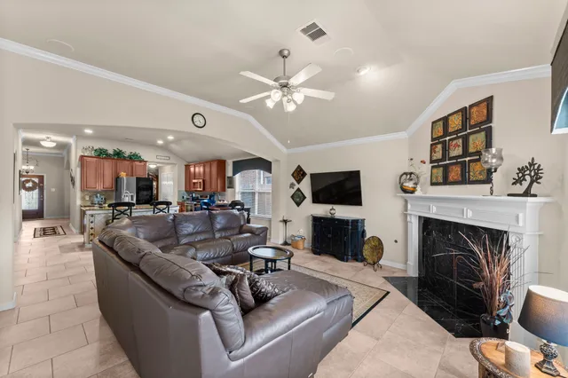 a living room with furniture a fireplace and a flat screen tv