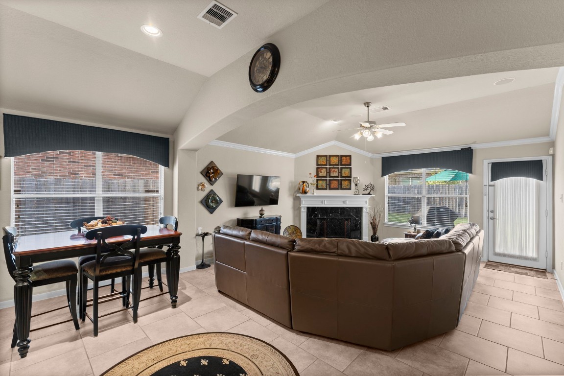 4618 Countrypines Drive Spring, TX 77388 - Photo 19 of 48 a living room with furniture a fireplace a flat screen tv and a large window