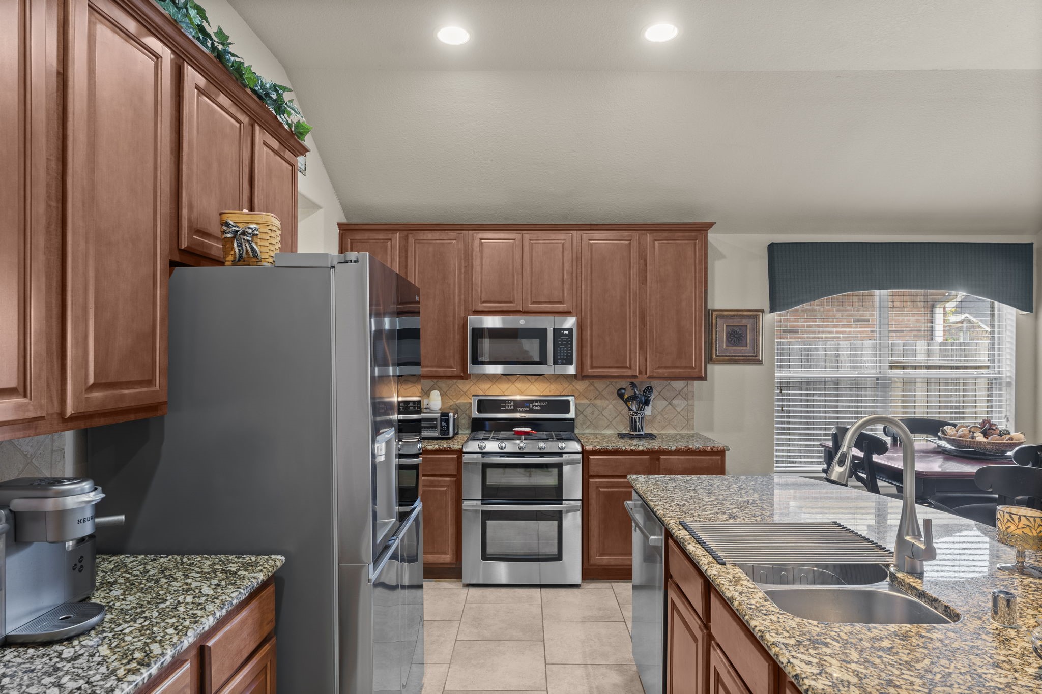 4618 Countrypines Drive Spring, TX 77388 - Photo 23 of 48 a kitchen with stainless steel appliances granite countertop a refrigerator stove and sink