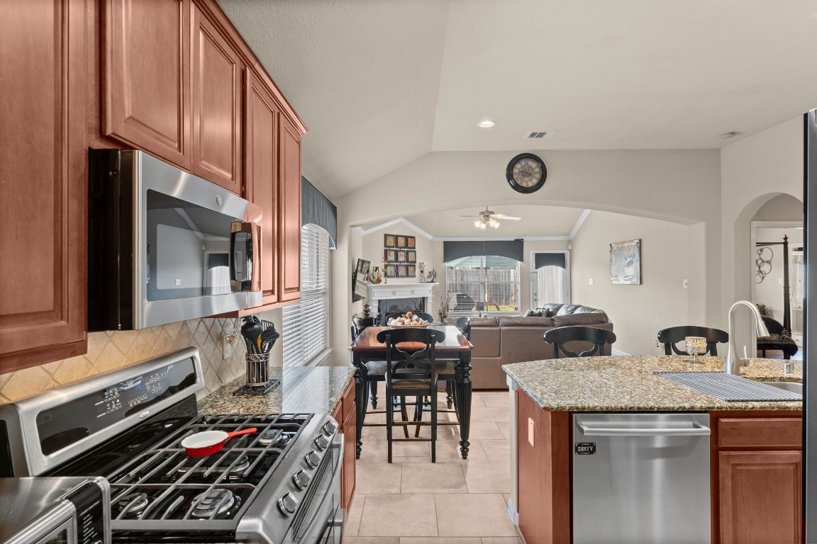 4618 Countrypines Drive Spring, TX 77388 - Photo 24 of 48 a kitchen with a table chairs stove and cabinets