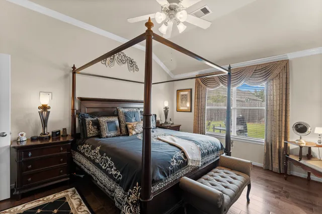 a bedroom with a bed and a chandelier