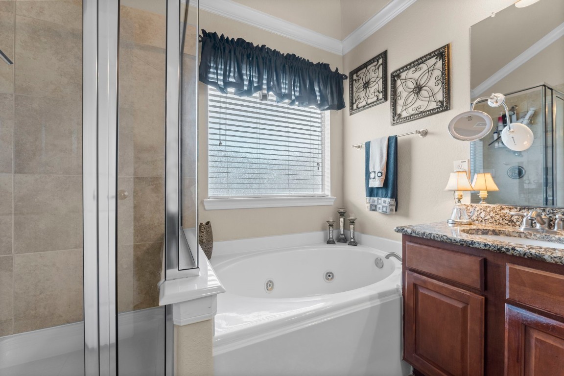 4618 Countrypines Drive Spring, TX 77388 - Photo 30 of 48 a bathroom with a granite countertop sink and a bathtub