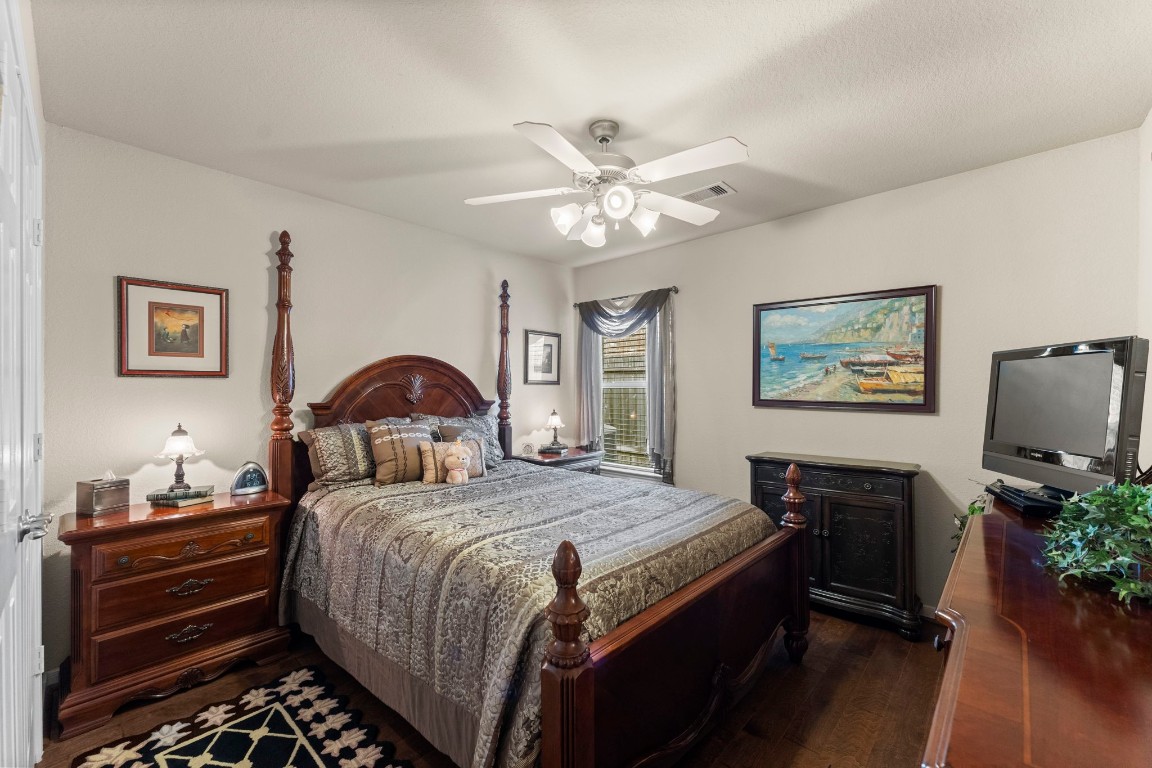4618 Countrypines Drive Spring, TX 77388 - Photo 34 of 48 a bedroom with a bed and a chandelier
