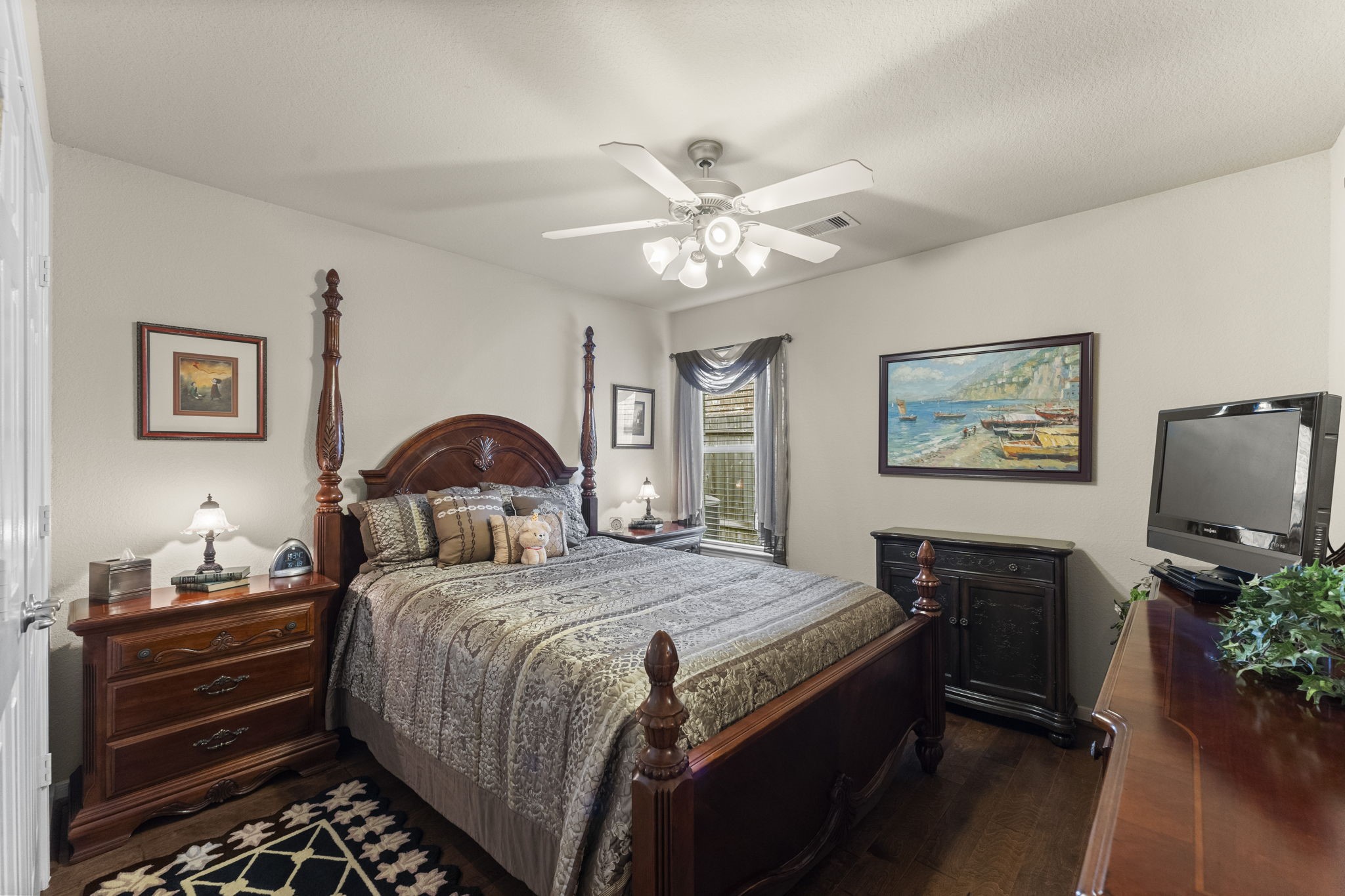 4618 Countrypines Drive Spring, TX 77388 - Photo 34 of 48 a bedroom with a bed and a chandelier