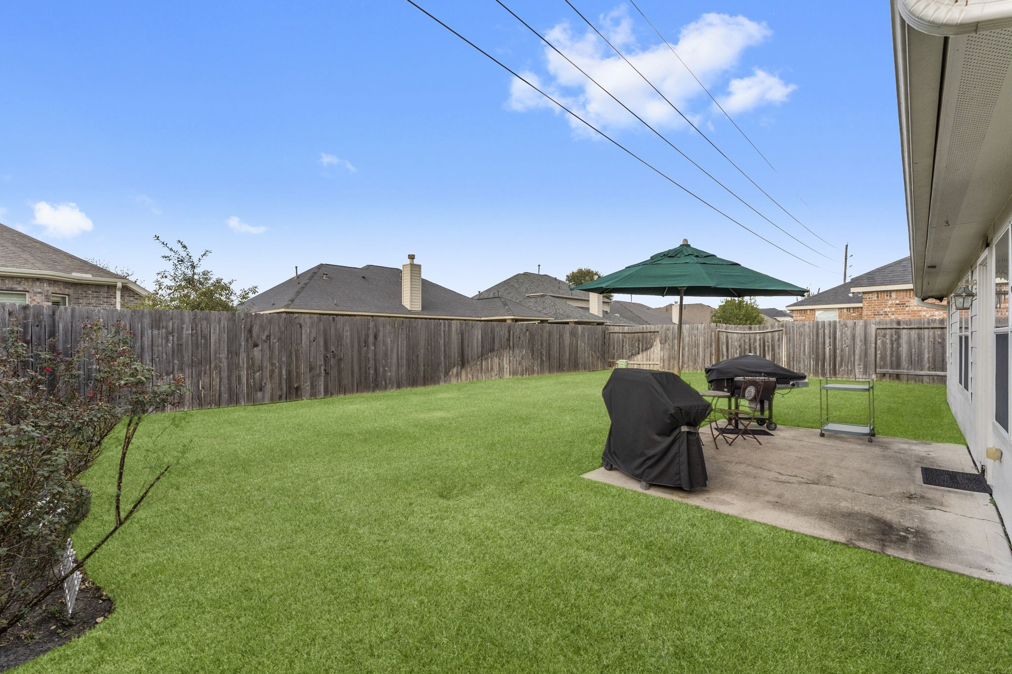 4618 Countrypines Drive Spring, TX 77388 - Photo 40 of 48 a view of a backyard with table and chairs under an umbrella