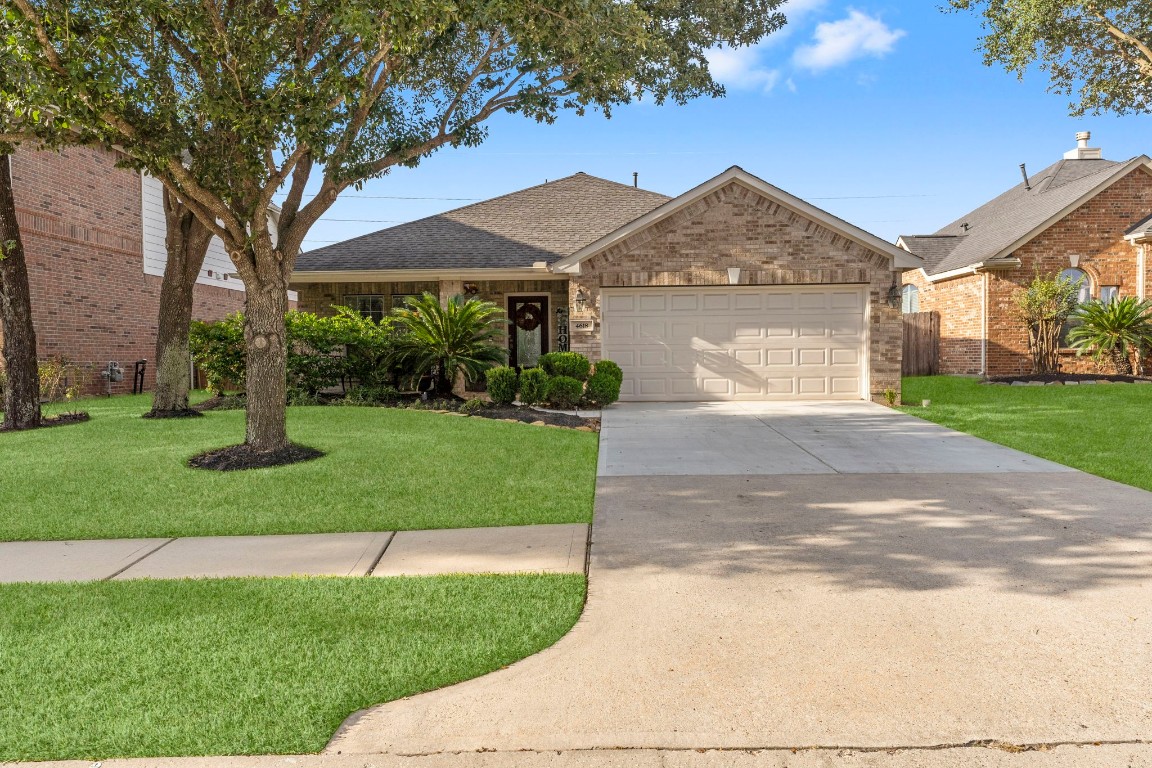 4618 Countrypines Drive Spring, TX 77388 - Photo 4 of 48 a front view of a house with a yard and garage
