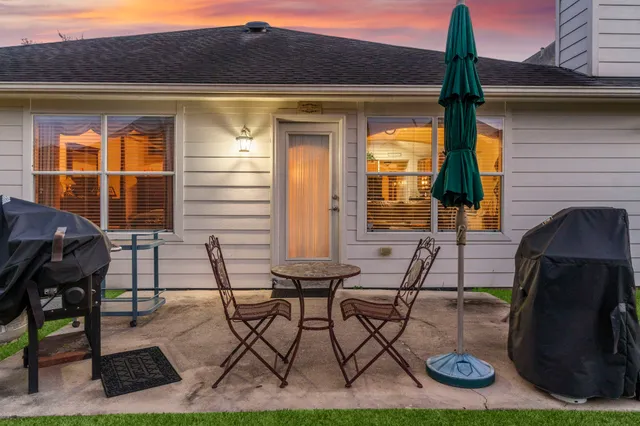 a patio with table and chairs