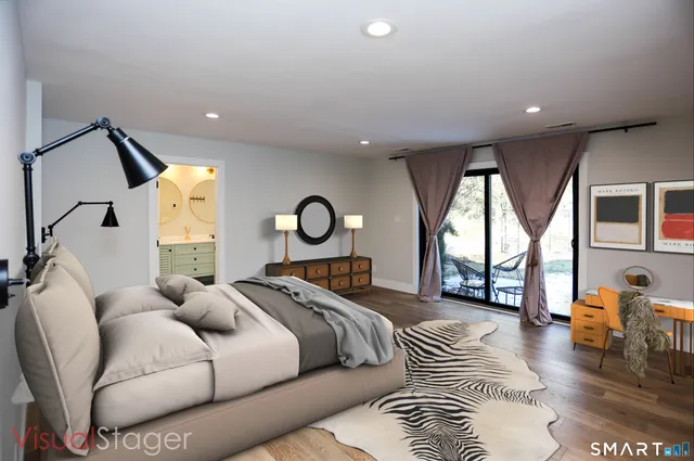 a spacious bedroom with a bed and a large window