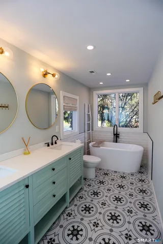 a bathroom with a toilet sink and mirror