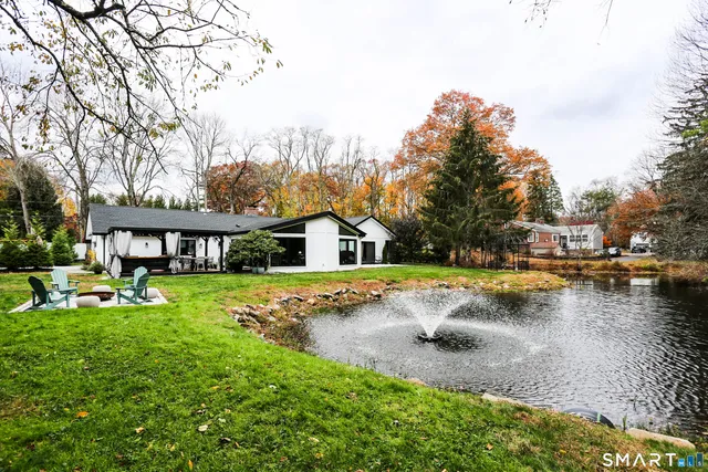 a view of a house with swimming pool and sitting area